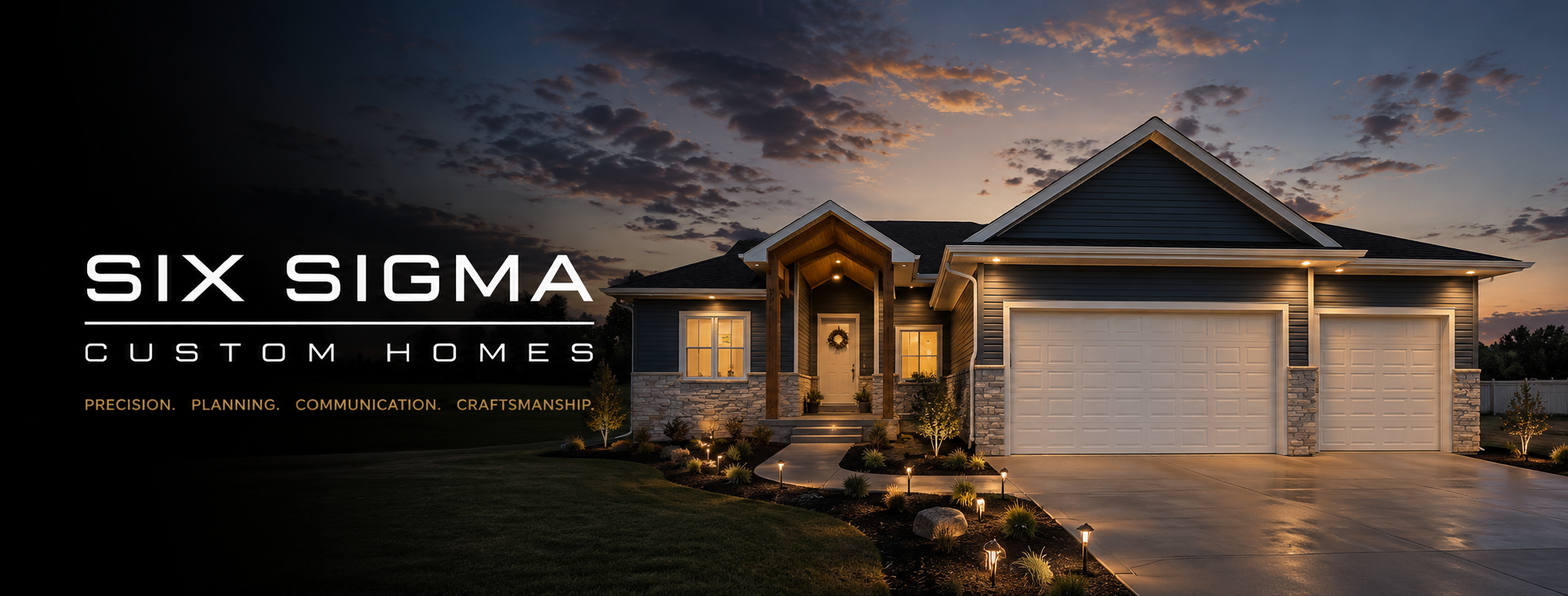 Dusk exterior of a Six Sigma custom home with stone accents and warm interior lighting